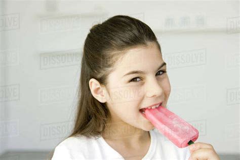 Little Girl Eating Popsicle Smiling At Camera Stock Photo Dissolve