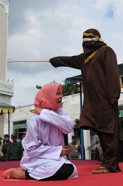 Woman Collapses In Agony As She And A Man Are Caned Under Sharia Law In