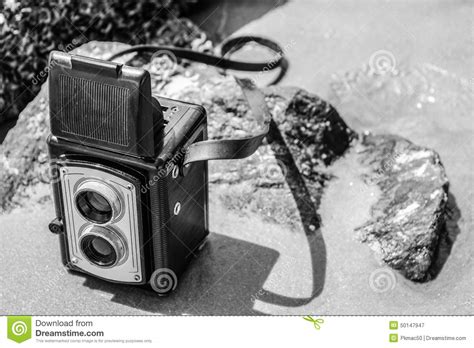 Vintage Camera On Beach In Black And White Stock Image