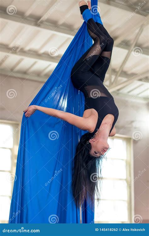 Acrobatic Gymnast Is Arching Her Back On The Beach Royalty Free Stock Image
