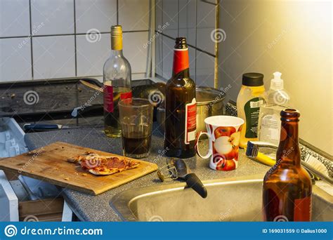Messy Kitchen After Party Beer Bottles Plates In A Sink