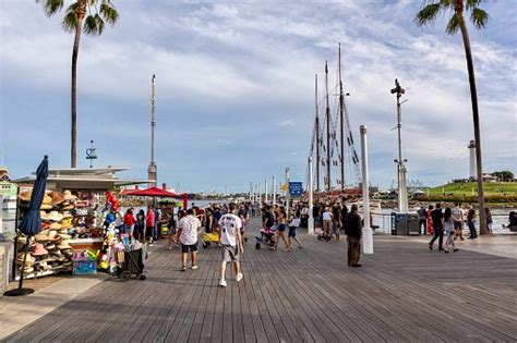 People Enjoying The Boardwalk In Long Beach By Shoreline Village Stock