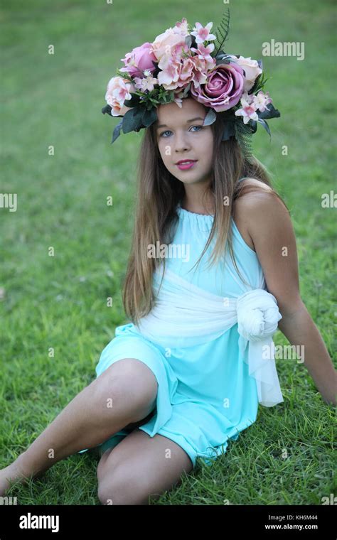 A Beautiful 12 Year Old Girl Dressed Up In A Light Blue Dress Wearing