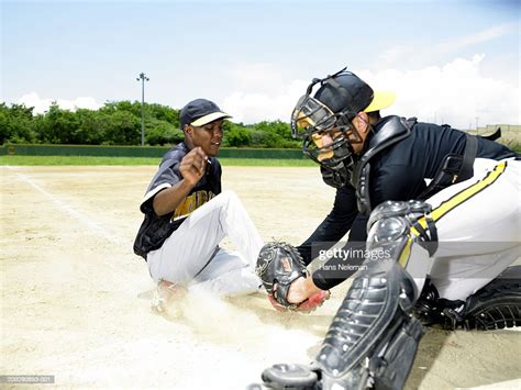 Baseball Player Sliding Into Home Plate Side View High Res Stock Photo