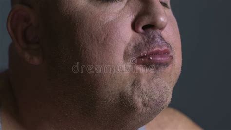 fat man chewing food delightfully inability to control junk food consumption stock footage