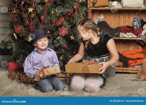 Brother And Sister At The Christmas Tree Stock Photo Image Of Floor