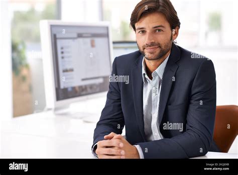 Lets Get Designing Portrait Of A Handsome Man Sitting At A Desk In An