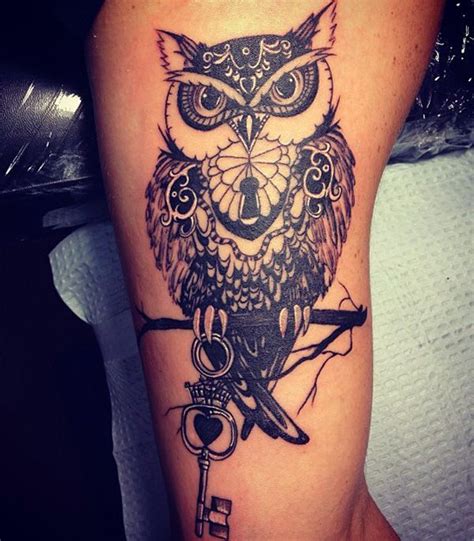 An Owl And Key Tattoo On The Arm