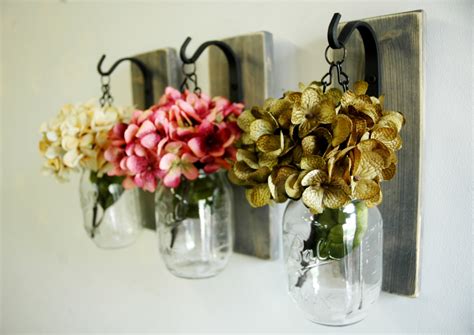 Whether you're decorating an apartment, setting up an etsy backdrop, or showcasing your artisan crafts, you'll find that these versatile jars aren't just for food storage or organizing bulk grains and spices anymore. Hanging Mason Jar Wall Decor Mason Jar Decor country decor