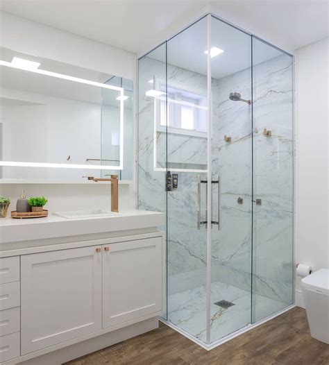 Banheiro com mix de porcelanatos madeira e mármore com espelho camarim fita de led Decor Salteado