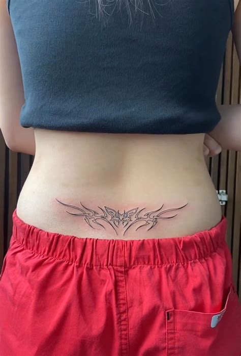 A Womans Stomach With A Small Tattoo On Her Lower Back And The Bottom Half