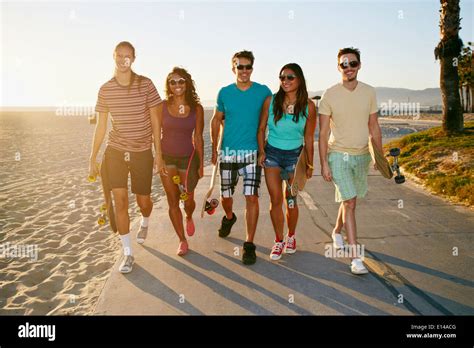 Friends Walking Together On Beach Stock Photo Alamy