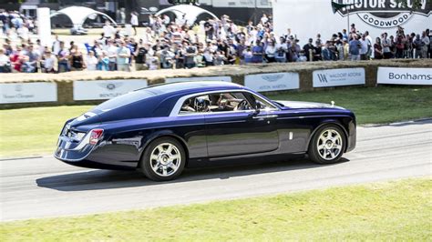 A full set of bespoke sweptail luggage fits in the trunk amid wood cladding and atop polished. Rolls-Royce Sweptail Was In No Hurry At Goodwood FOS