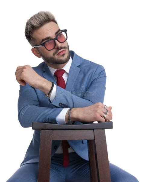 Attractive Businessman Resting On A Chair And Looking Away Stock Photo