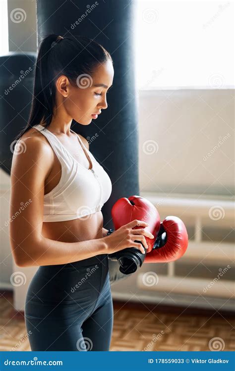 Sporty Tiired Woman Wearing Boxing Gloves Posing In Gym Stock Image