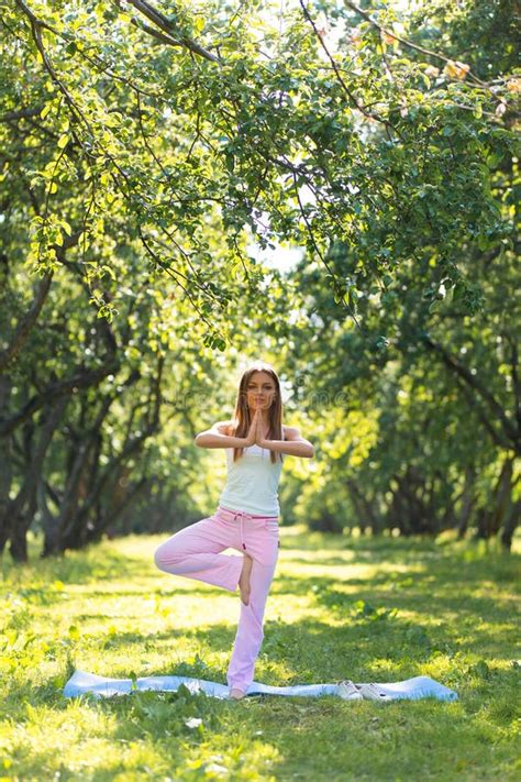 Beautiful Girl Doing Yoga In The Park Stretching Exercises Stock Photo