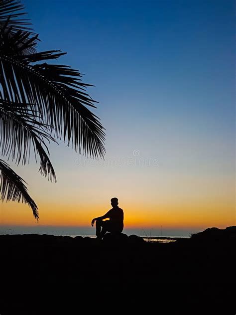 Sad Man Sitting On The Rock In The Beach Stock Photo Image Of Rock