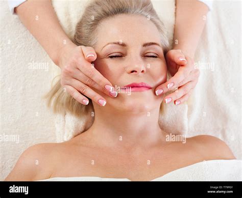 face massage in spa environment macro attractive woman with close eyes taking skin care