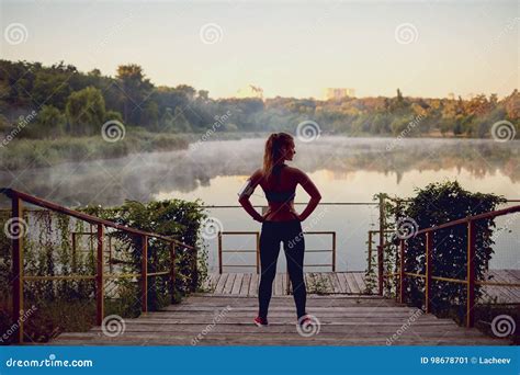 Girl Runner Before Jogging In Morning By The Lake In The Park In Stock