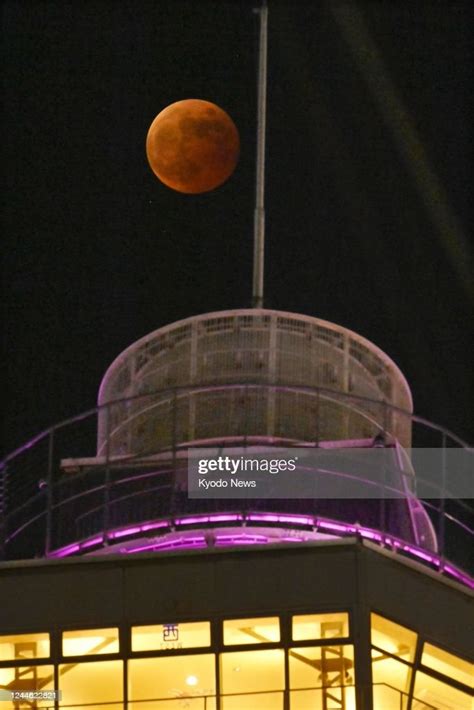 A Total Lunar Eclipse Is Seen Above The Iconic Tsutenkaku Tower In