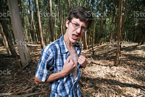 Young Man Ripping At His Shirt In The Woods Stock Photo Download