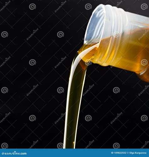 Pouring Synthetic Oils For Car Engine On Dark Background Stock Photo