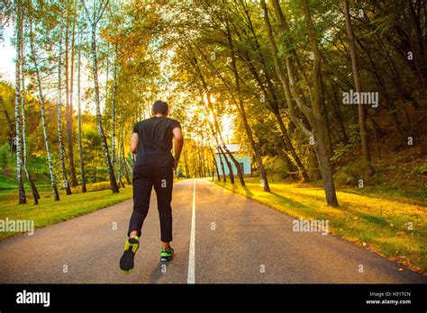 Male Athlete Runner Running On Road Jog Workout Well Being Concept
