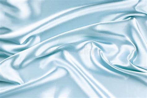 Beautiful Light Blue Background With Drapery And Wavy Folds Of Silk