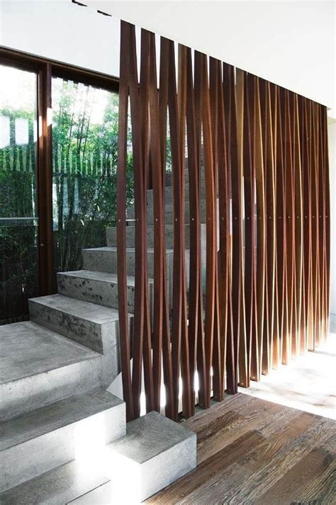 A Wooden Slatted Wall Next To Some Stairs