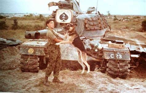 Marine Jimmy Logan Playing A Dog In Front Of A M48 Patton
