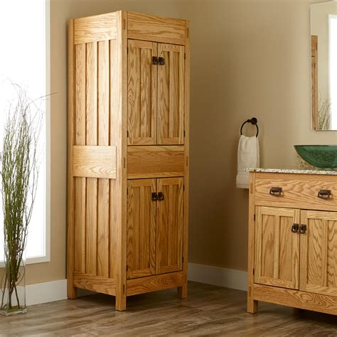 The blue cabinet holds four woven seagrass baskets for a more whimsical look. 72" Mission Linen Cabinet - Bathroom