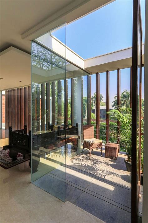 Wooden Slats Glass Walls And Modern Grandeur Gallery House In India