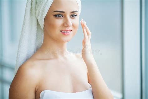 A Beautiful Woman Using A Skin Care Product Moisturizer Or Lotion And