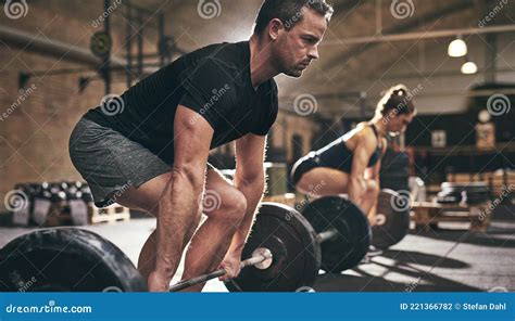 Spotive Man And Woman Lifting Heavy Barbells Stock Photo Image Of