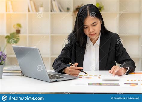 Asian Female Accountant Or Banker Calculating Savings Finance And Economy Concepts Via Laptop