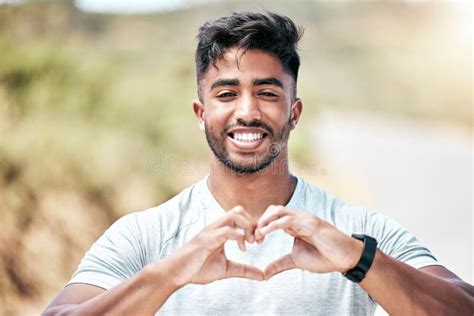 Portrait Happy Fit Young Mixed Race Man Making A Heart Shape With His