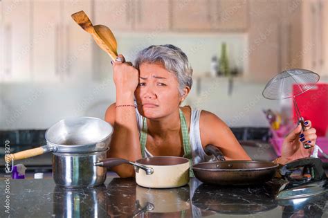 Attractive Upset And Stressed Woman 40s To 50s Tired And Unhappy At Home Kitchen Doing Housework