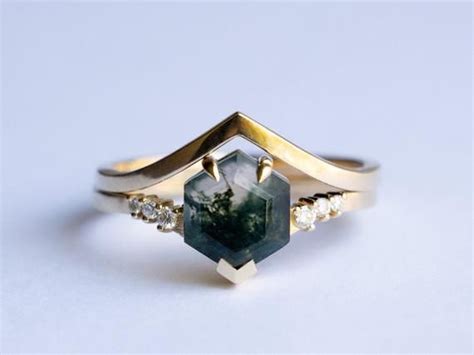 A one-of-a-kind moss agate engagement ring set with side diamonds and a