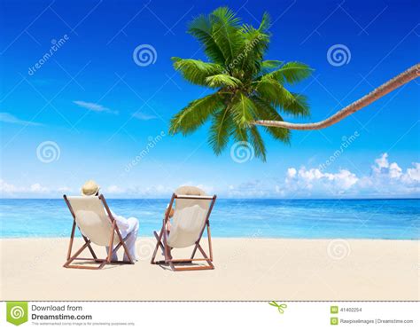 Couple Relaxing On The Tropical Beach Stock Photo Image