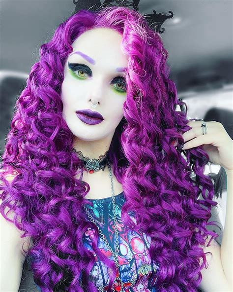 A Woman With Long Purple Hair And Green Eyes