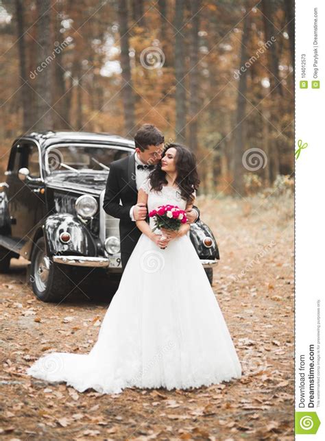 Beautiful Wedding Couple Posing Near Splendid Retro Car Stock Image