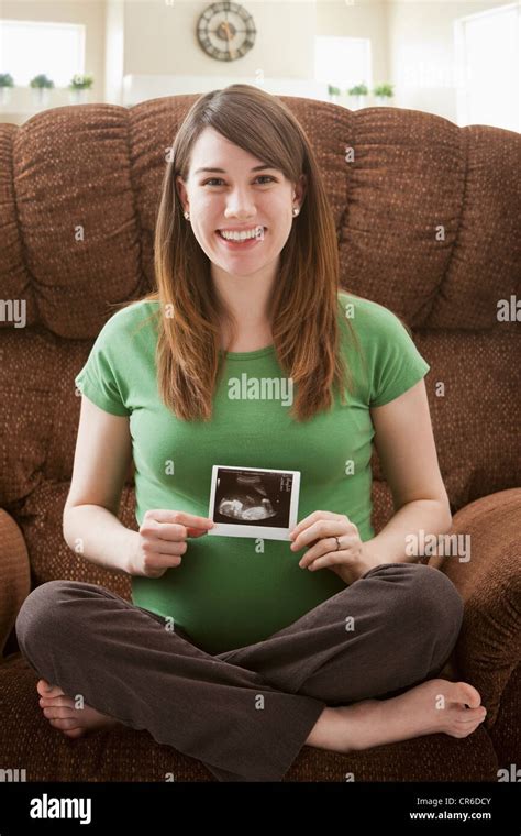 Portrait Of Pregnant Woman Showing Ultrasonography Scan Stock Photo Alamy