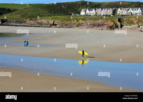 Surfers On Beach At Polzeath At Low Tide Cornwall England Uk Stock