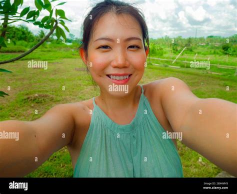 Young Happy And Attractive Asian Chinese Woman Taking Selfie Self Portrait With Mobile Phone At
