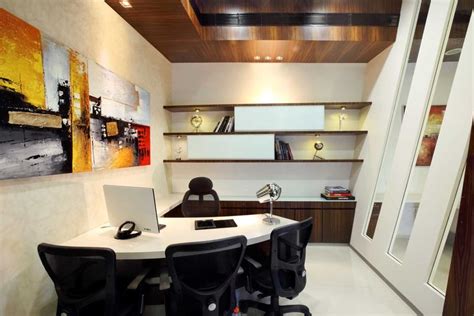 An Office With Two Black Chairs And A White Table In Front Of A