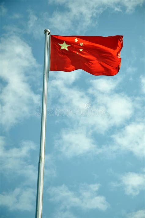 China Flag Flag Of The Peoples Republic Of China Against Blue Clouds