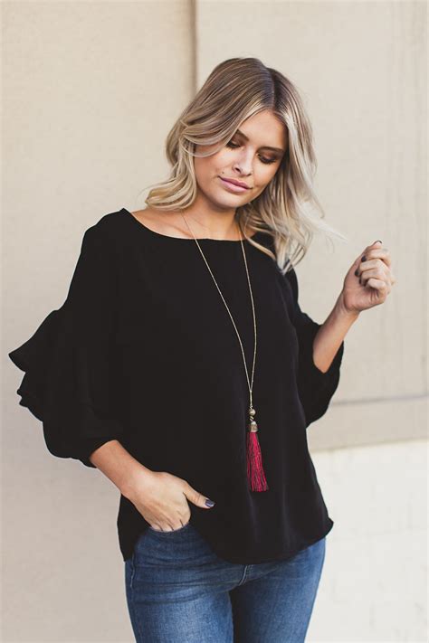 A Black Ruffle Top Denim Jeans A Statement Necklace Make The