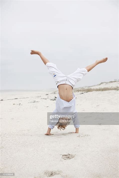 Boy Doing Handstand On Beach High Res Stock Photo Getty Images