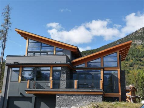 The house has a gentle butterfly roof with a built in scupper to collect rainwater in an area with difficult well access. butterfly roof exterior rustic with wood siding copper ...