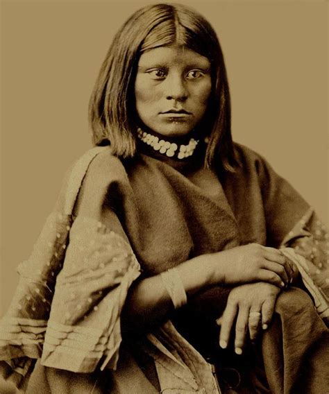 An Old Photo Of A Native American Woman With Her Hand On Her Hip And